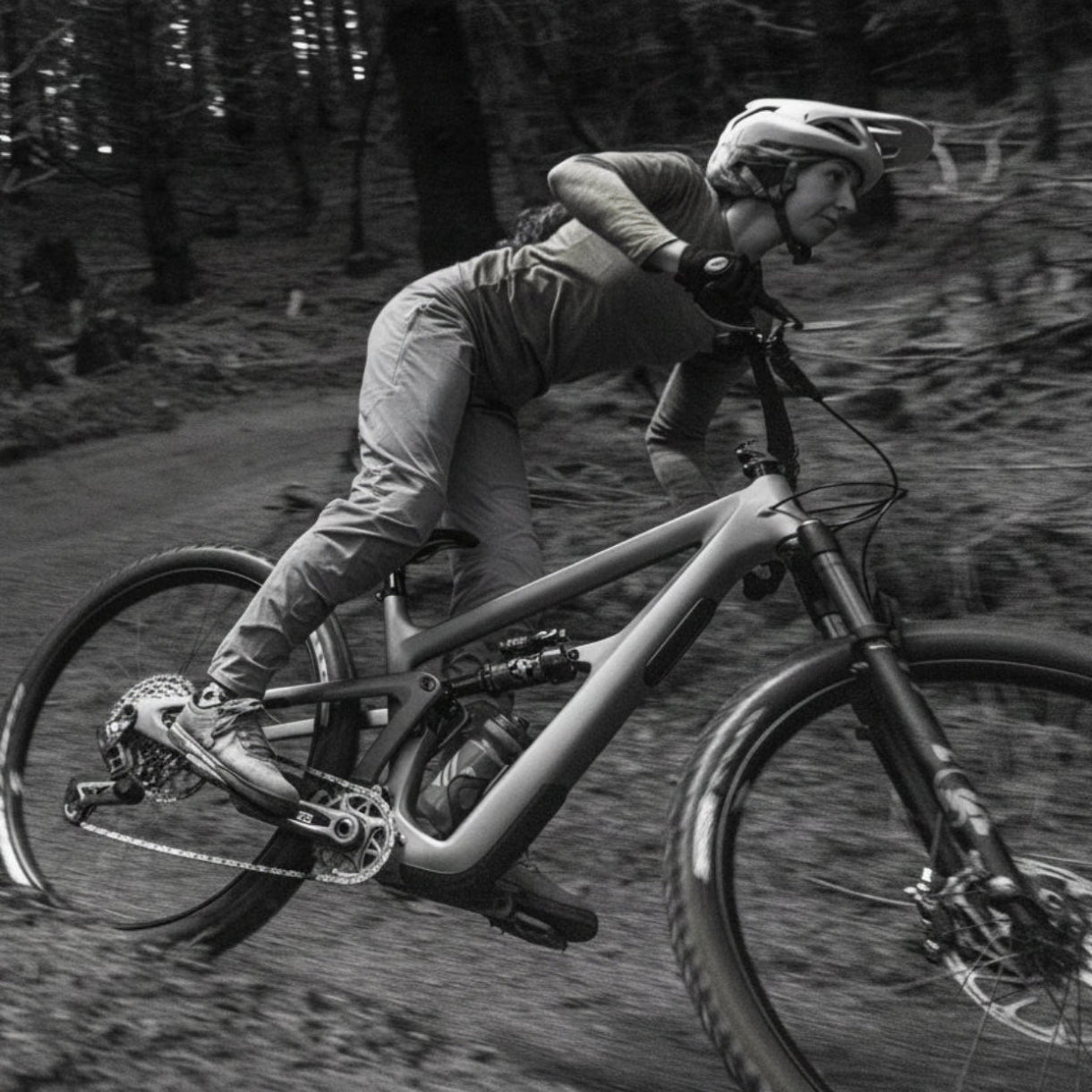 Person riding a mountain bike on a dirt path in a forest